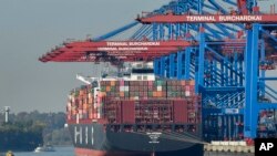 FILE - A container ship is loaded at the harbor in Hamburg, Germany, Oct. 15, 2018.