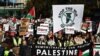 Protesters gather with placards and flags for the 'National March For Palestine' in central London on November 11, 2023, calling for a ceasefire in the conflict between Israel and Hamas.