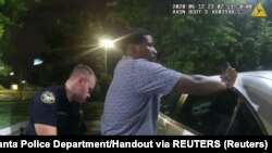 USA, Georgia, Atlanta, Former Atlanta Police Department officer Garrett Rolfe conducts a field sobriety test on 27-year-old Rayshard Brooks 