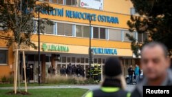 Police officers stand guard near the site of a shooting in front of a hospital in Ostrava, Czech Republic, December 10, 2019. REUTERS/Lukas Kabon