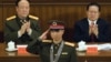 2005年11月，中国中央军委副主席郭伯雄（左）和公安部长周永康（右）参加庆祝神舟六号完成航天飞行的仪式