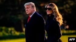 President Donald Trump and First Lady Melania Trump walk towards Marine One as they depart the White House en route to Mar-a-Lago, the President's private club, where they will spend Christmas and New Years Eve in Washington, DC on December 23, 2020…