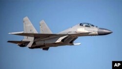 In this undated file photo released by the Taiwan Ministry of Defense, a Chinese PLA J-16 fighter jet flies in an undisclosed location. China sent a record 28 fighter jets, 14 of them J-16s, towards the self-ruled island of Taiwan on Tuesday, June…