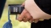 A woman holds a Bible at an open air Sunday church service 