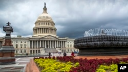 FILE- In this May 30, 2018, file photo the East Front of the U.S. Capitol in Washington is seen under stormy skies. On Tuesday, June 12, the Treasury Department releases federal budget data for May. (AP Photo/J. Scott Applewhite, File)