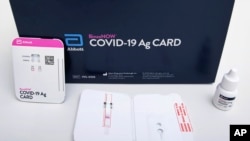 This image provided by Abbott Laboratories in August 2020 shows the company's BinaxNOW rapid COVID-19 nasal swab test. The Food and Drug Administration on Wednesday, Aug. 26, 2020, authorized BinaxNOW, the first rapid coronavirus test that doesn’t need an